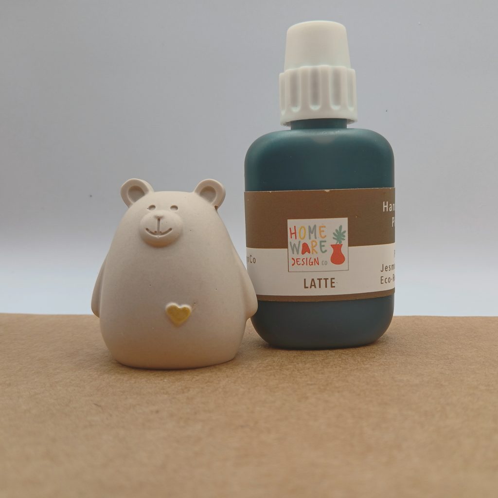 Small bear with gold heart next to a bottle of eco resin pigment
